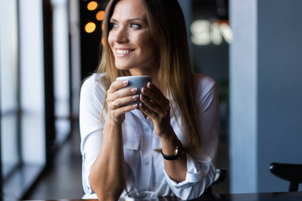 woman drinking coffee in the morning at restaurant - Фото, зображення