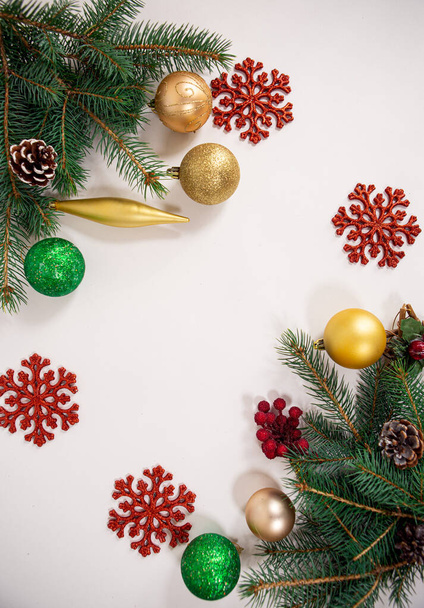 background with bright Christmas decorations and green needles of a festive tree - Fotografie, Obrázek
