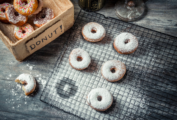 Tasting sweet donuts with icing sugar - 写真・画像