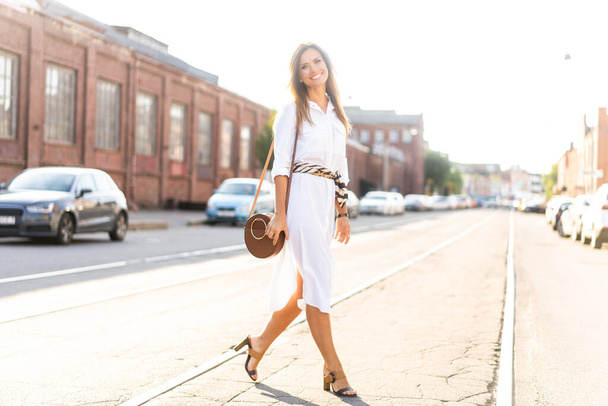 Happy young business woman walking on the street. - Foto, imagen