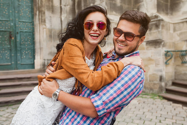 young couple in love traveling, vintage style, europe vacation, honey moon, sunglasses, old city center, happy positive mood, smiling, embracing - Photo, image
