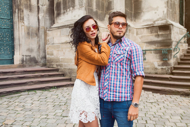 young couple in love traveling, vintage style, europe vacation, honey moon, sunglasses, old city center, happy positive mood, smiling, embracing - Zdjęcie, obraz