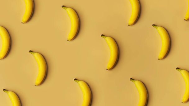 Background from bananas in a row on a golden background - Фото, изображение