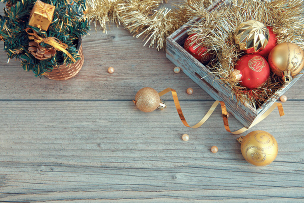 Christmas or New Year composition, wood background background with gold Christmas decorations - Foto, imagen