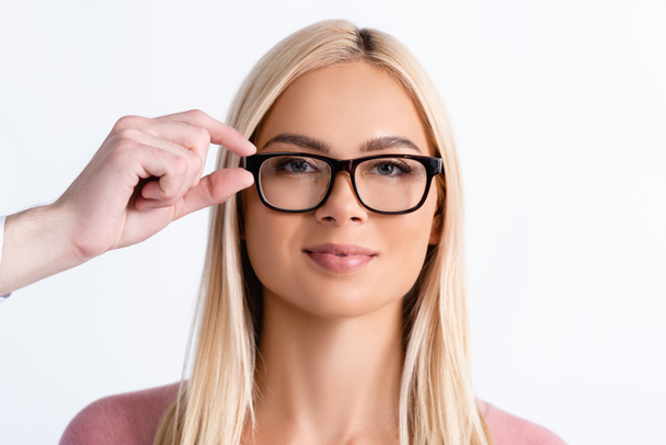 Ophthalmologist holding eyeglasses frame of blonde woman isolated on white - Photo, Image