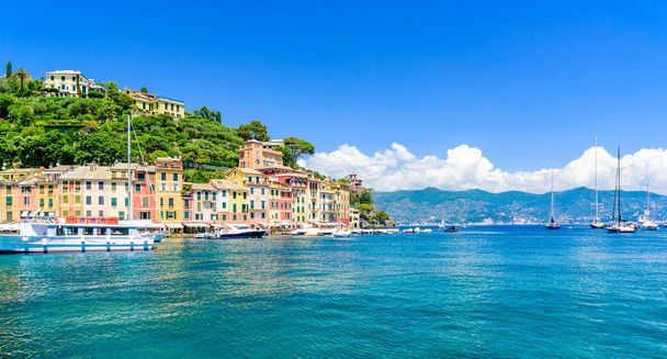 Portofino, Italy - Harbor town with colorful houses and yacht in little bay. Liguria, Genoa province, Italy. Italian fishing village with beautiful sea coast landscape in summer season. - Фото, зображення