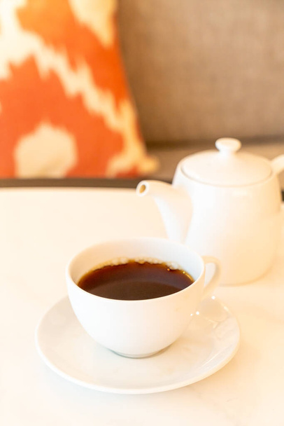 white tea cup with teapot on table - Fotó, kép
