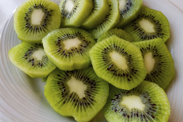 close up sliced kiwi fruits on white plate - Photo, Image