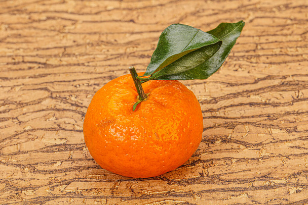 Ripe sweet tasty tangerine with green leaves - Photo, Image