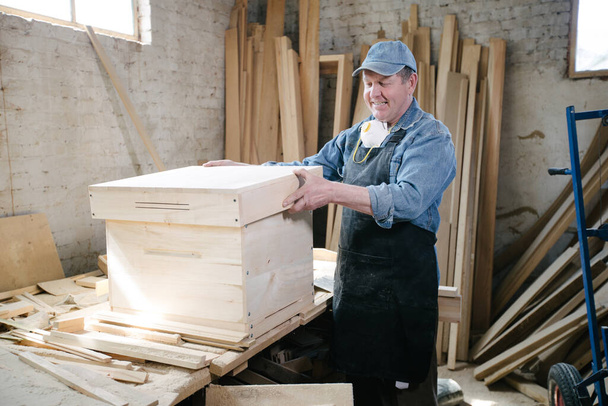 Carpenter man posing in carpentry workshop - 写真・画像