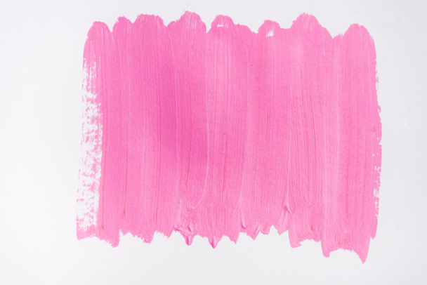 top view of abstract pink paint brushstrokes on white background - Foto, Imagen