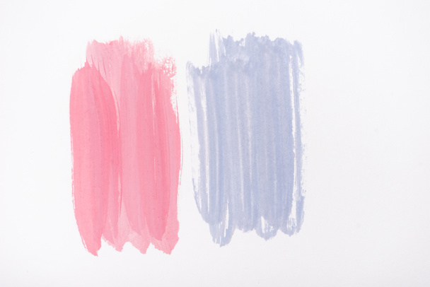 top view of abstract pink and blue paint brushstrokes on white background - Fotoğraf, Görsel