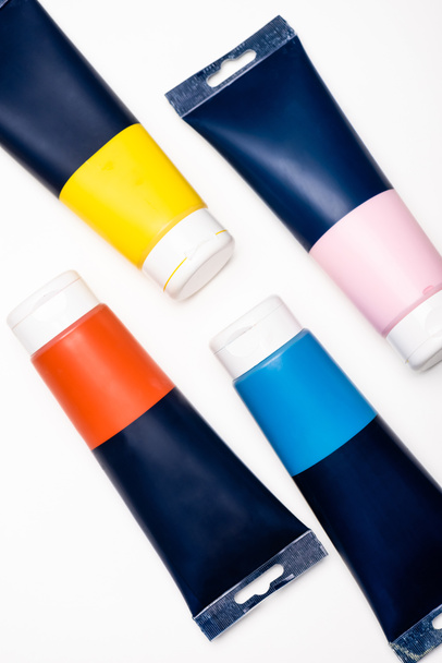 top view of acrylic paint tubes on white background - Foto, afbeelding
