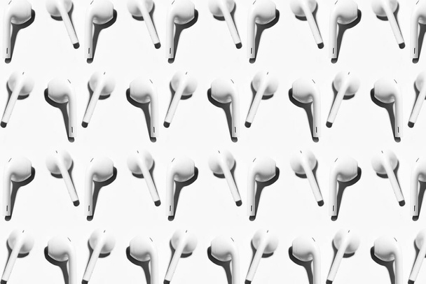 Pattern of wireless earphones isolated on white background. - Photo, Image