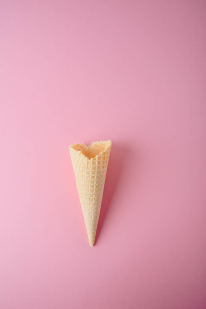 Empty waffle cone on a pink background close-up - Fotoğraf, Görsel