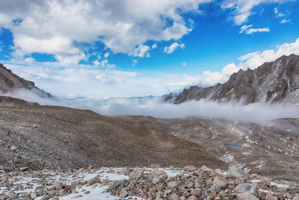 Vista del paisaje de montaña en Kirguistán. Rocas, nieve y piedras en vista al valle de la montaña. Panorama de montaña. - Foto, imagen