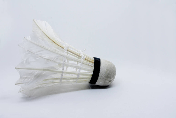 Shabby shuttlecock. Some of the feathers have been damaged and lost. - Photo, Image