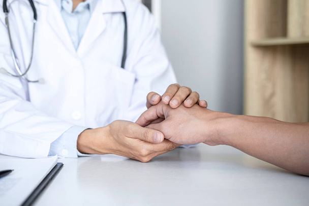Close up of doctor touching patient hand for encouragement and empathy on the hospital, cheering and support patient, Bad news, medical examination, trust and ethics. - Foto, Imagem