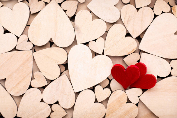 Wooden hearts, one red heart on the wooden heart background. - Foto, Imagem