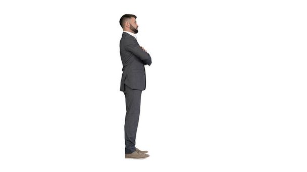 Confident business man with beard and mustashes in suit standing with folded hands on white background. - Foto, Imagen