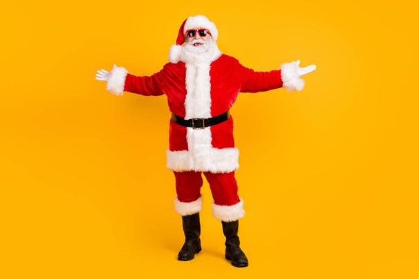 Full length body size view of his he nice funny cheerful cheery positive white-haired Santa fooling having fun rest chill grimacing isolated bright vivid shine vibrant yellow color background - 写真・画像
