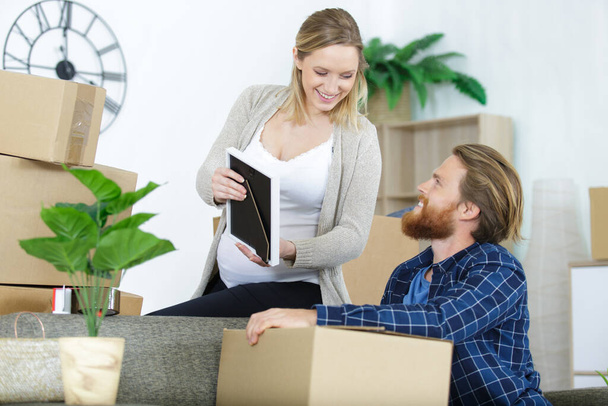 young couple moving to new flat with fragile things - Photo, Image