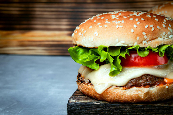  Large burger with cheese close-up, photo with copyspace - Zdjęcie, obraz