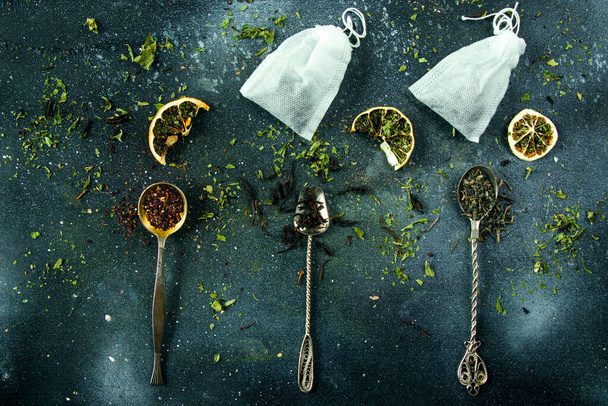 Set of tea on the vintage silver spoons, various of tea and teabags - Фото, изображение