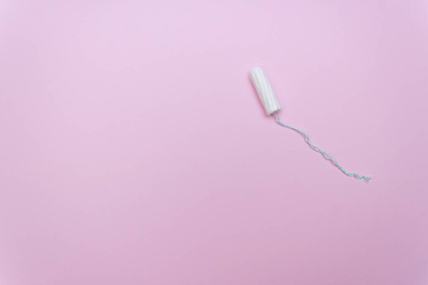 One white tampon. Woman hygiene for period days, menstrual mothly cycle. Protective care for woman health - Zdjęcie, obraz