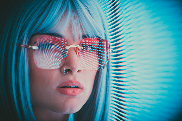 Image of a beautiful young woman posing against a led panel. teenager with alternative look and grey wig making urban portraits - Foto, imagen
