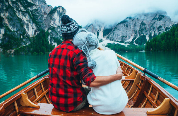 Mountain stories. Happy couple on a wanderlust vacation. Boyfriend and girlfriend spending time together at the lake. Storytelling concept about lifestyle and winter travels - Zdjęcie, obraz