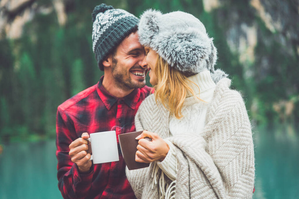 Mountain stories. Happy couple on a wanderlust vacation. Boyfriend and girlfriend spending time together at the lake. Storytelling concept about lifestyle and winter travels - Photo, Image
