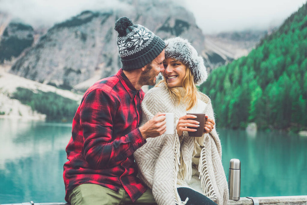 Mountain stories. Happy couple on a wanderlust vacation. Boyfriend and girlfriend spending time together at the lake. Storytelling concept about lifestyle and winter travels - Photo, image