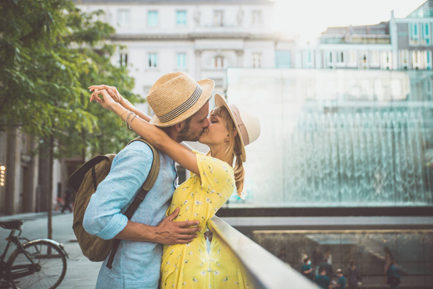 Image of a happy couple on vacation. Young man and woman doing some shopping in the city center. - Foto, imagen