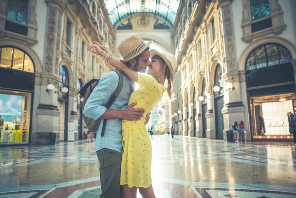 Image of a happy couple on vacation. Young man and woman doing some shopping in the city center. - Foto, Imagem