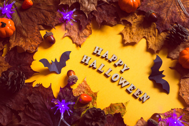 Colorful leaves frame on yellow background with copy space. Halloween background. - Photo, image