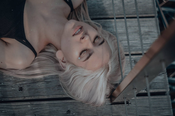 The blonde girl on the pier. in a black leather jacket - Fotografie, Obrázek