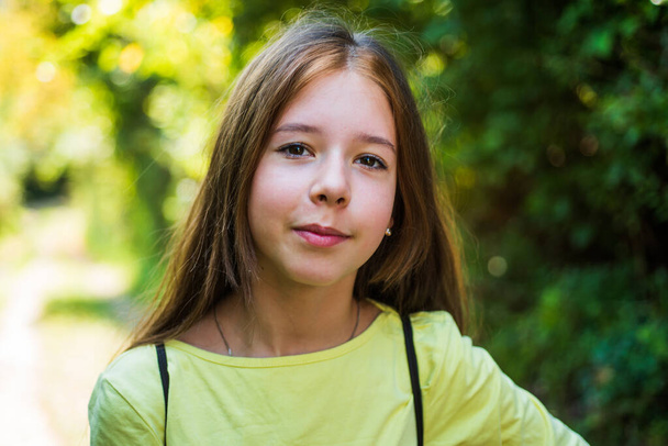 beautiful teen girl walking outdoor in summer or spring, childhood - Foto, imagen