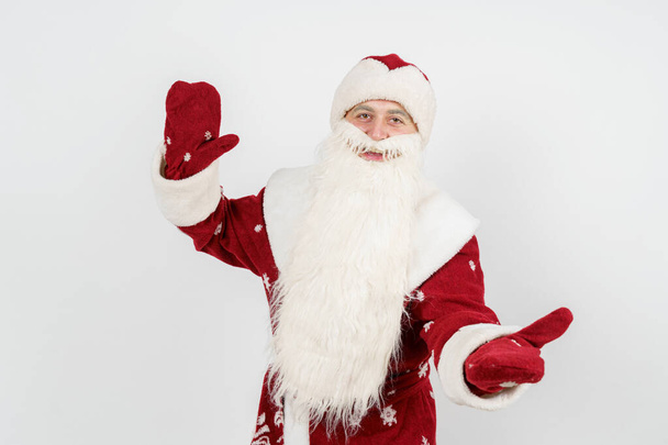 Christmas and New Years concept. Santa Claus gestures with his hands, spreading them apart from admiration. Isolated background. - Foto, afbeelding