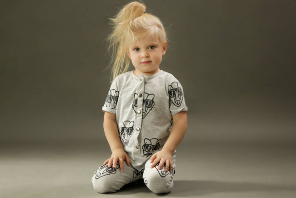 Studio shot of 3 years old fashionable kid on the grey background - Foto, Imagem