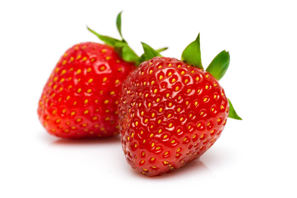 two ripe juicy strawberries on a white background - Zdjęcie, obraz