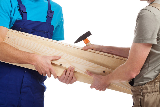 Builders holding timber - 写真・画像