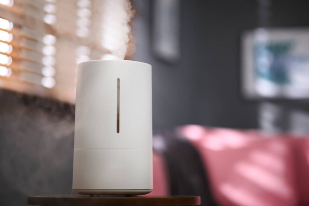 Modern air humidifier on table indoors. Space for text - 写真・画像