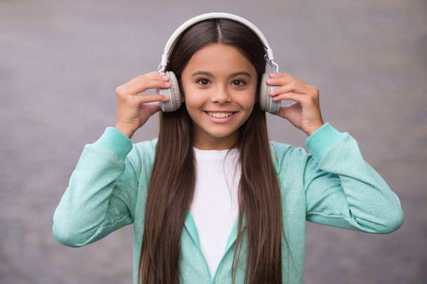 happy school kid listen music or audio book in headphones for education and joy, childhood - Photo, image