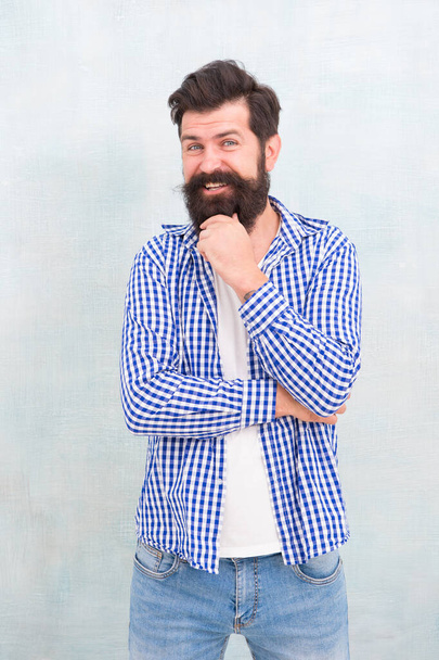 Barbering at its best. Happy bearded man blue background. Unshaven hipster smile in casual style. Barbershop. Barber shop. Haircut and shave salon. Barbershop service. Beard grooming. Haircare - Valokuva, kuva