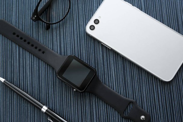 Flat lay composition with stylish smart watch on black table - Fotografie, Obrázek