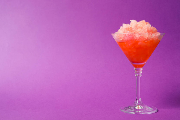 Shaving ice in martini glass on violet background, space for text - Zdjęcie, obraz