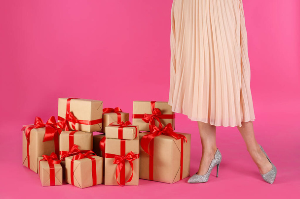 Woman and gift boxes on pink background, closeup. Black Friday Sale - Photo, Image