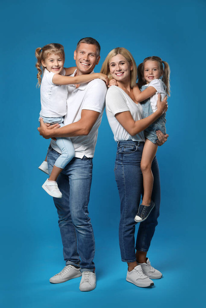 Happy family with children on blue background - Fotó, kép