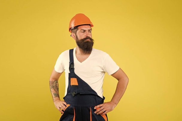 Man builder hard hat. Creativity and practice. Major renovation places strong emphasis natural materials and sustainability. Improvement and renovation. Brutal man builder. Engineer builder uniform - Φωτογραφία, εικόνα